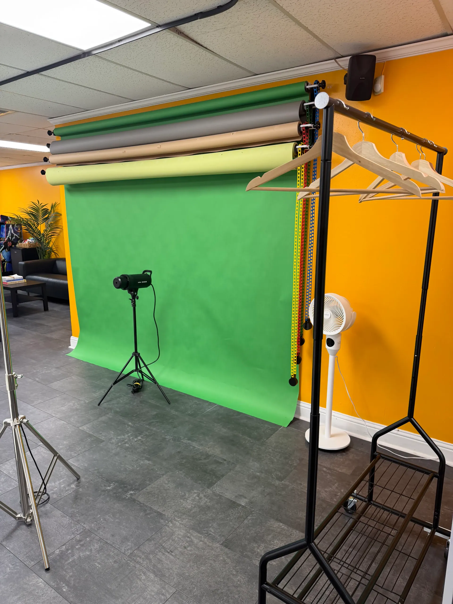 Multi-roll backdrop station with garment rack