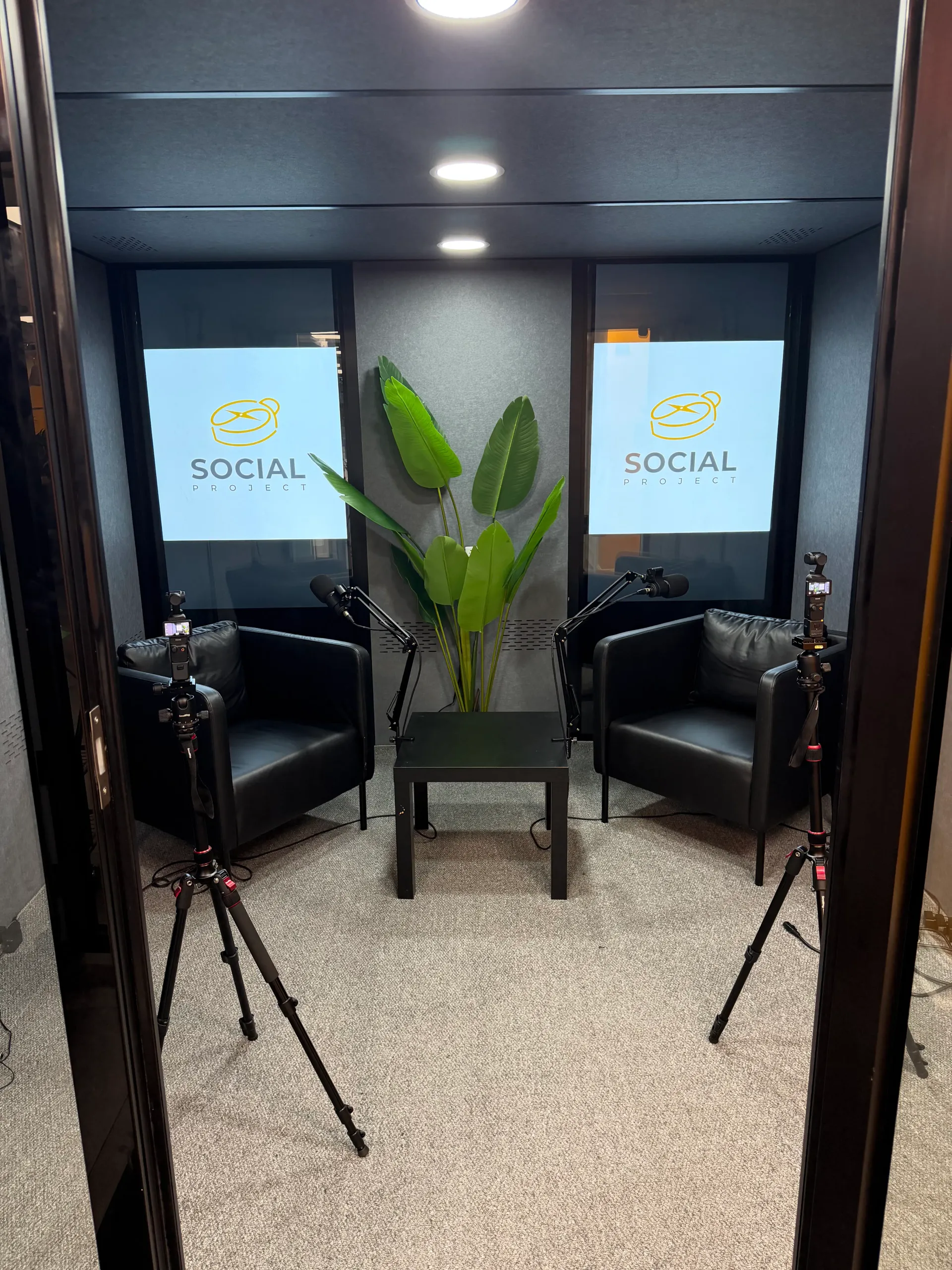 Podcast setup with cameras, microphones and Social Project branding