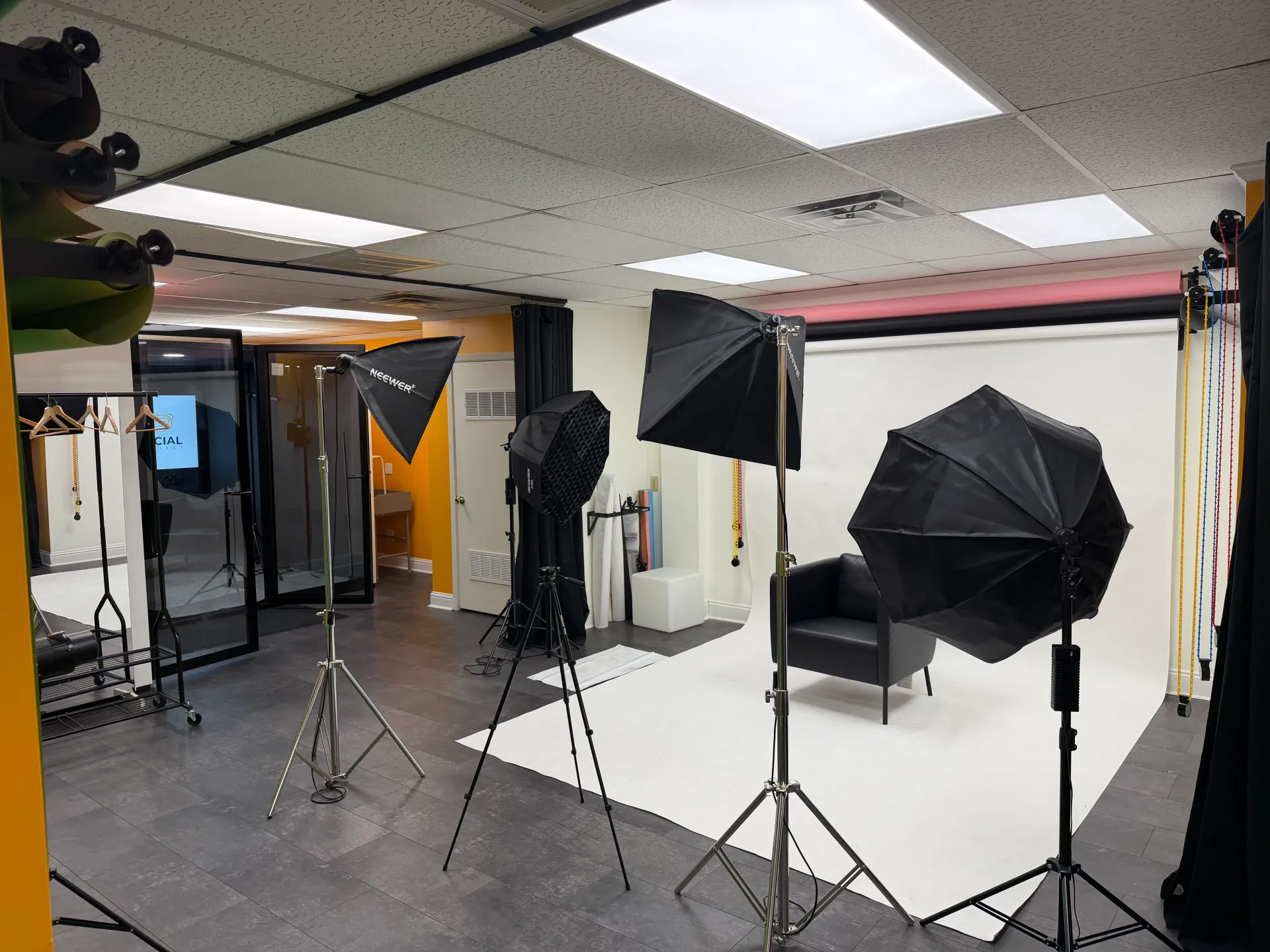 Photography studio with white backdrop and professional lighting
